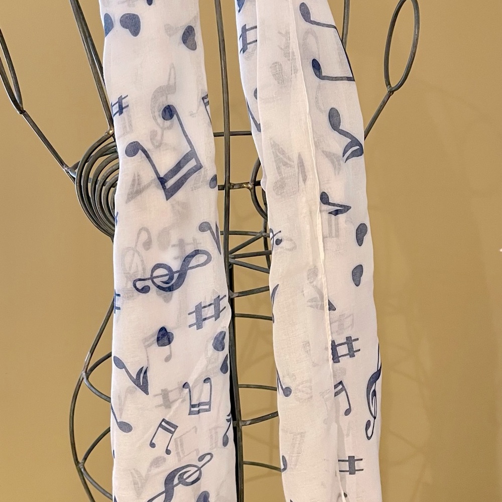Musical notes scarf 62” x 20” approx. Brand new.  White with medium blue notes.